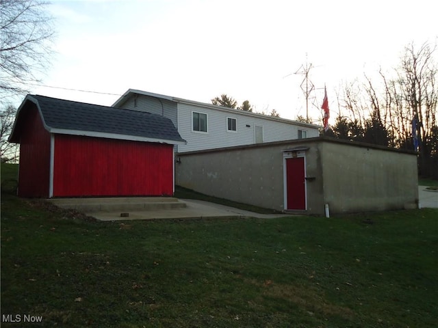 outdoor structure at dusk featuring a lawn