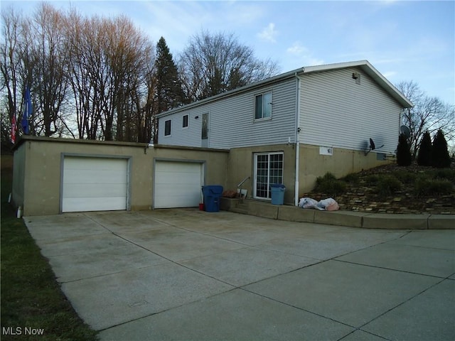 rear view of house featuring a garage