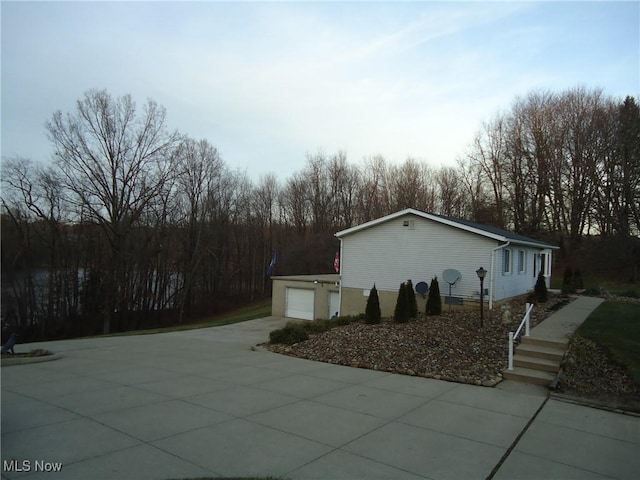 view of side of home featuring a garage