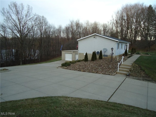 view of side of home featuring a garage