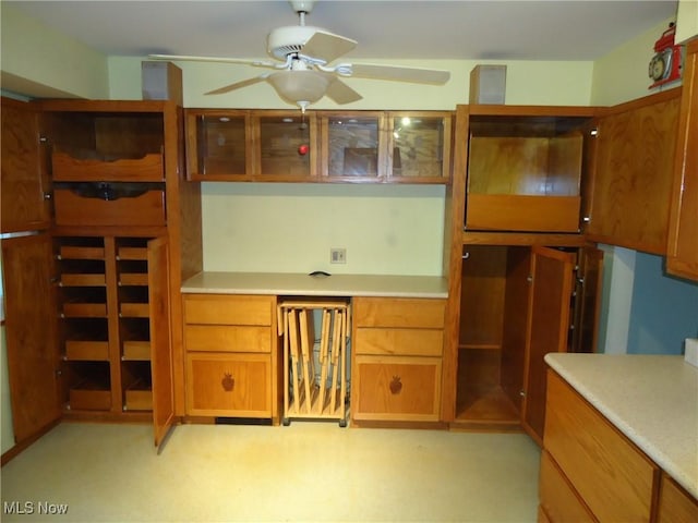 kitchen featuring ceiling fan and built in desk