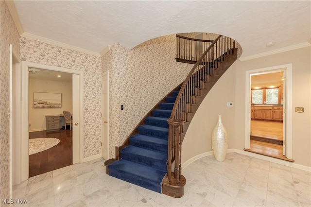 staircase featuring a textured ceiling, wood-type flooring, and crown molding