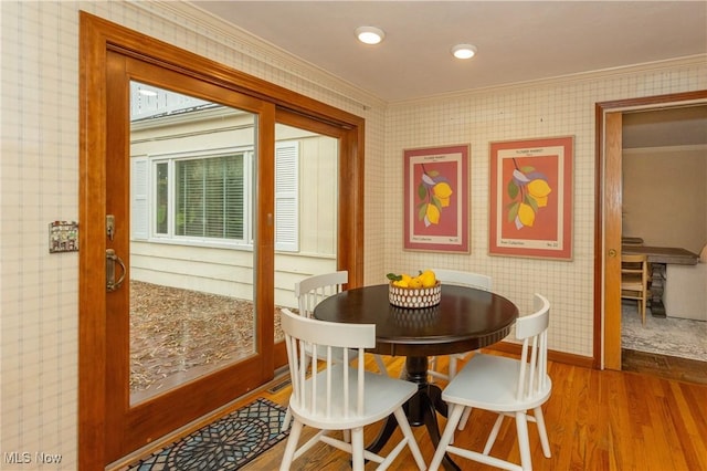 dining room featuring hardwood / wood-style floors and ornamental molding