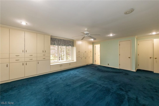 unfurnished bedroom with ceiling fan, ornamental molding, and dark colored carpet