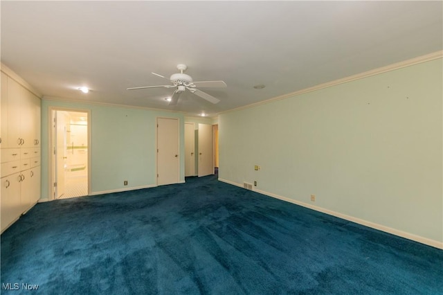 carpeted empty room with ceiling fan and crown molding