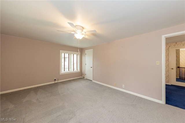 carpeted empty room featuring ceiling fan