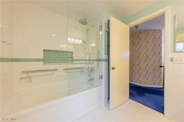 bathroom featuring tile patterned flooring and enclosed tub / shower combo