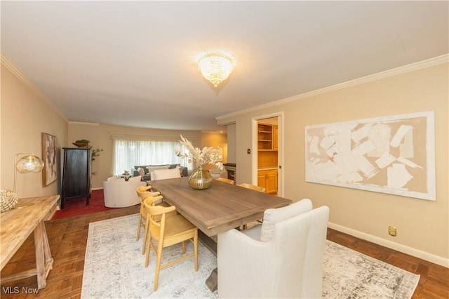 dining space featuring crown molding