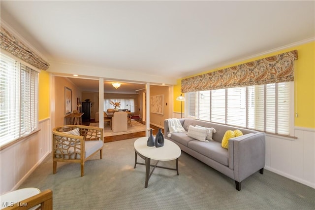 living room featuring carpet and crown molding