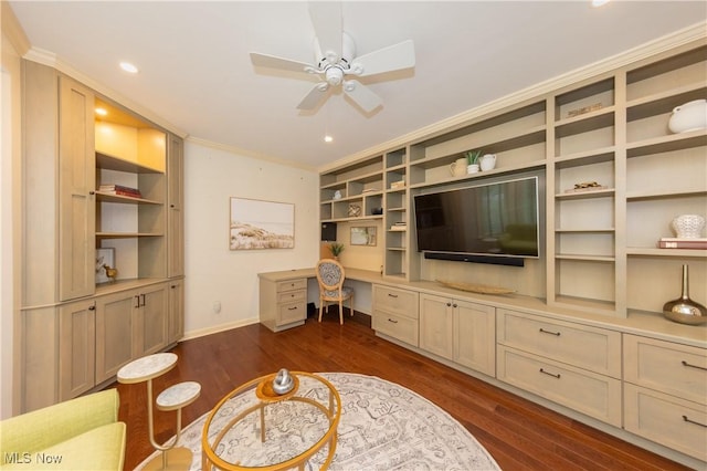 living room featuring ceiling fan, dark hardwood / wood-style flooring, ornamental molding, and built in desk