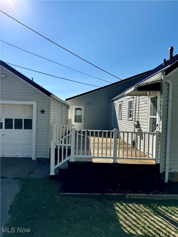 exterior space with a wooden deck and a garage