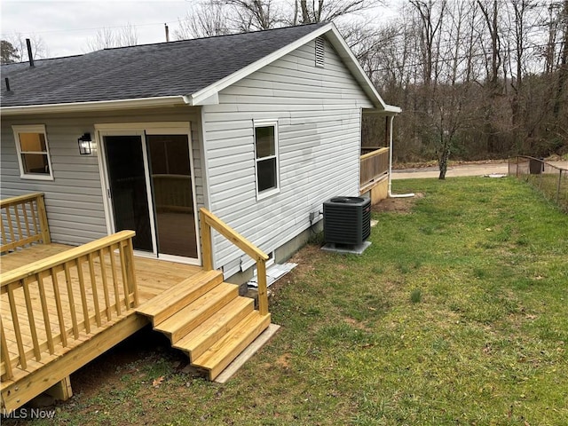 back of property featuring a yard, central AC unit, and a wooden deck