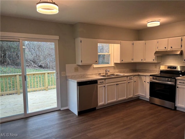 kitchen with white cabinets, dark hardwood / wood-style floors, and appliances with stainless steel finishes