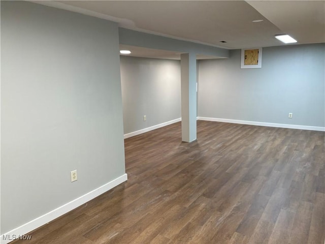 basement with dark hardwood / wood-style flooring