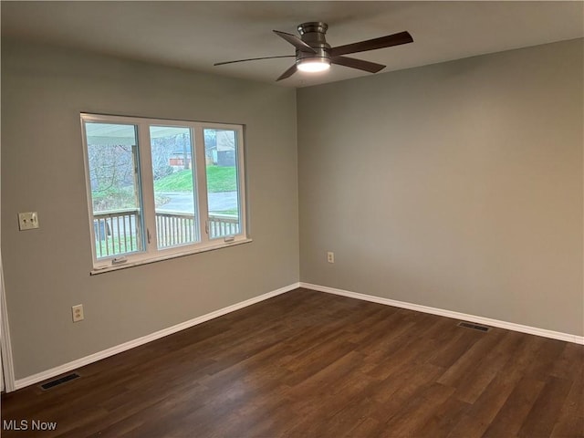 unfurnished room featuring ceiling fan and dark wood-type flooring