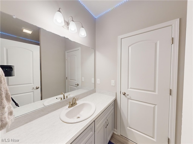 bathroom with hardwood / wood-style floors and vanity