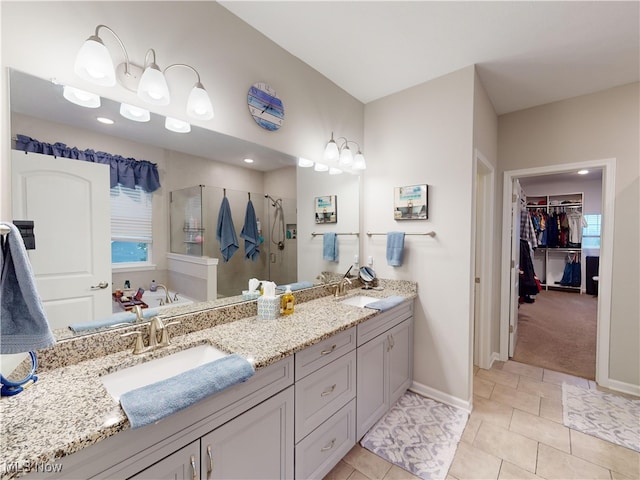 bathroom featuring tile patterned floors, vanity, and shower with separate bathtub