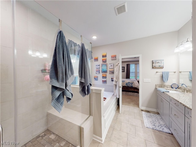 bathroom with tile patterned floors, plus walk in shower, and vanity