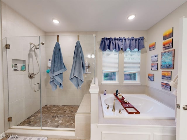 bathroom featuring separate shower and tub