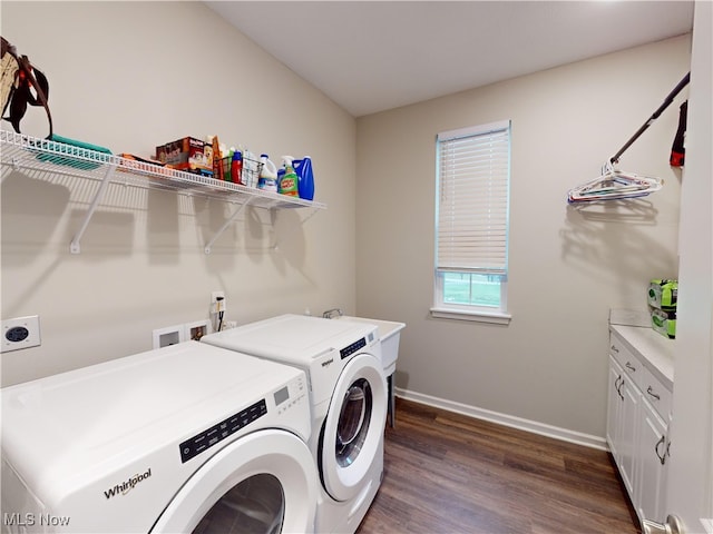 laundry area with cabinets, dark wood-type flooring, and washing machine and dryer