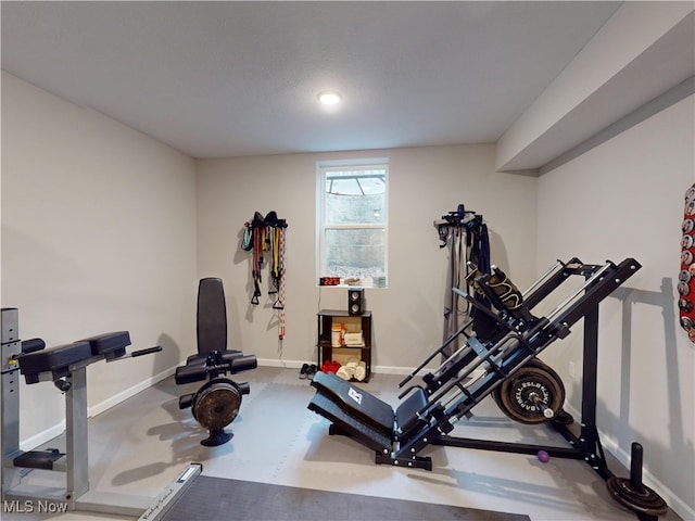 exercise area featuring a textured ceiling