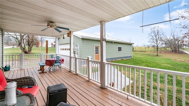 wooden deck with ceiling fan and a yard