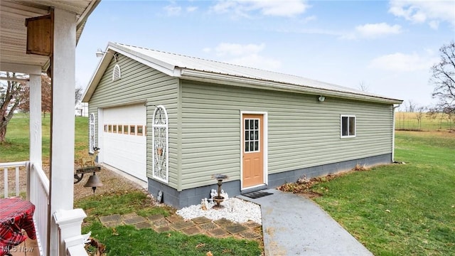 view of outbuilding featuring a lawn and a garage