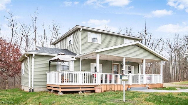 view of front of home with covered porch and a front yard