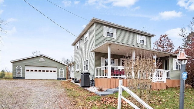 view of front of property with a porch, a garage, an outdoor structure, and cooling unit