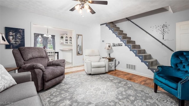 living room featuring ceiling fan and wood-type flooring