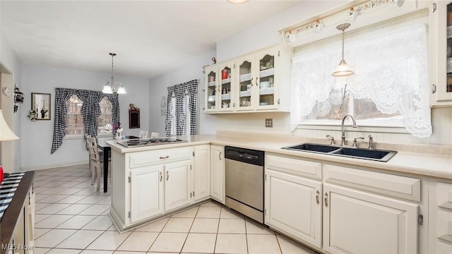 kitchen featuring hanging light fixtures, light tile patterned floors, stainless steel appliances, and sink