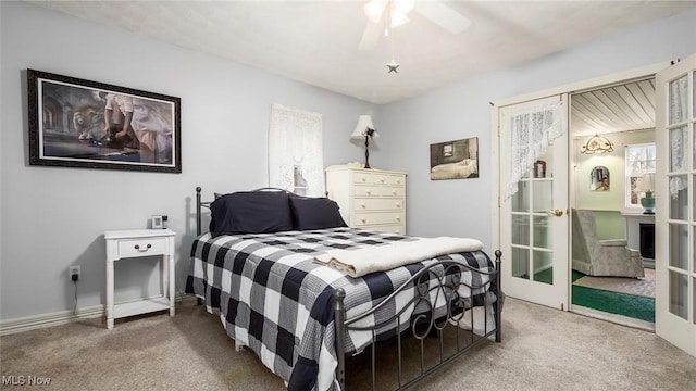 carpeted bedroom with ceiling fan and french doors