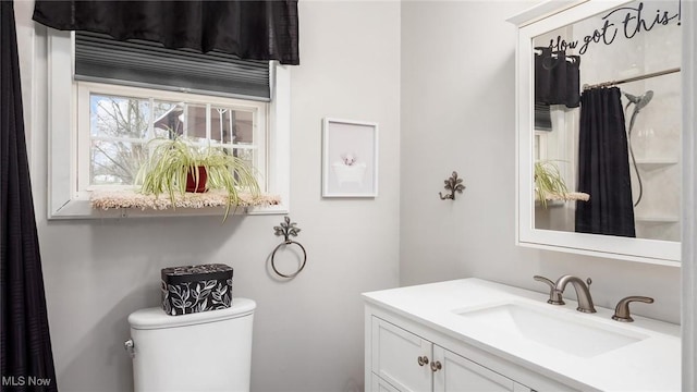 bathroom featuring vanity and toilet