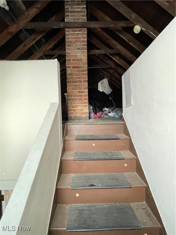 stairs featuring lofted ceiling