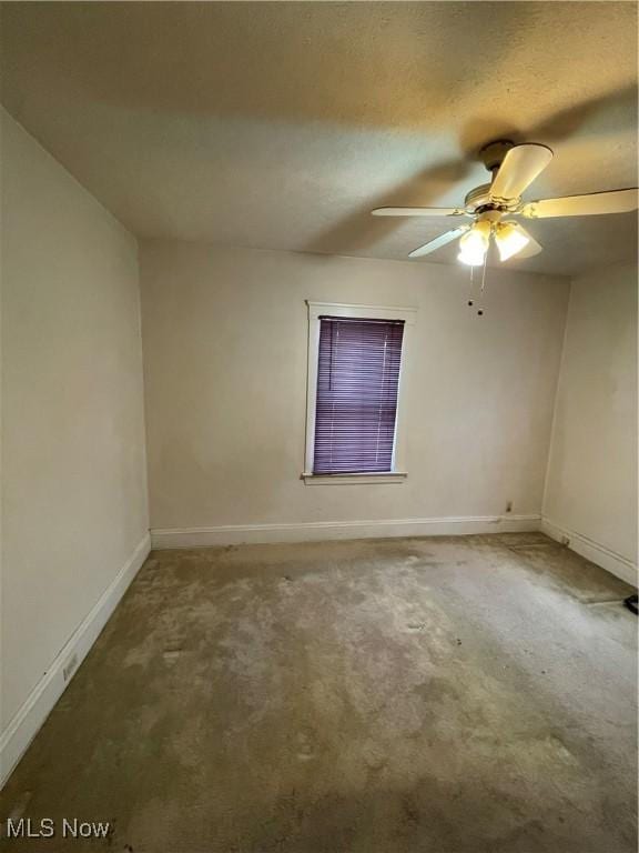 empty room featuring carpet flooring and ceiling fan