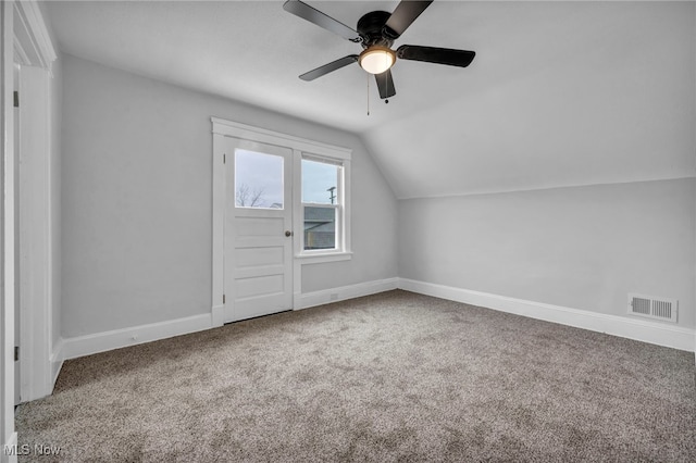 additional living space with ceiling fan, carpet floors, and vaulted ceiling