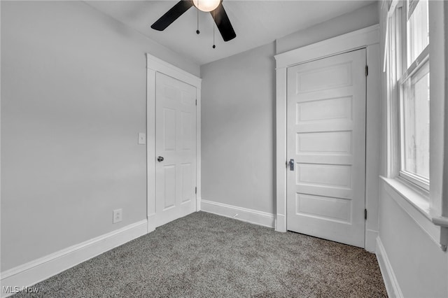 unfurnished bedroom featuring ceiling fan and carpet floors