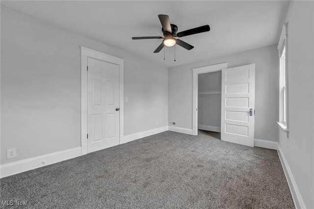 unfurnished bedroom featuring carpet flooring, multiple windows, and ceiling fan