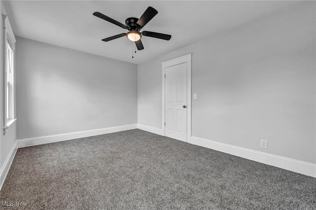 carpeted spare room featuring ceiling fan