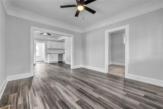 unfurnished living room featuring dark hardwood / wood-style flooring and ceiling fan