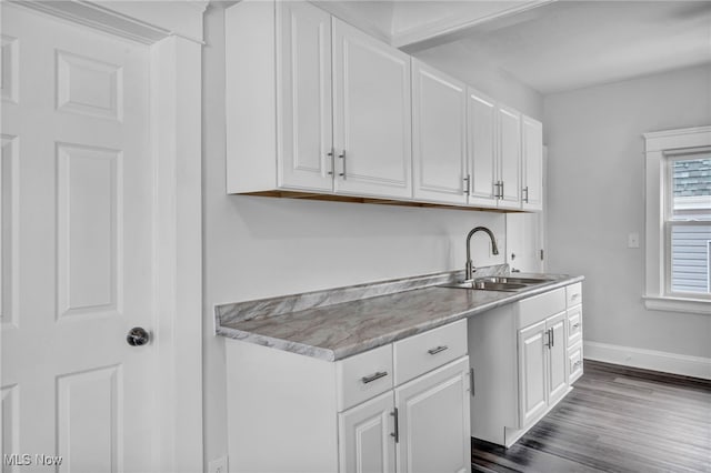 kitchen featuring white cabinetry, sink, and dark wood-type flooring