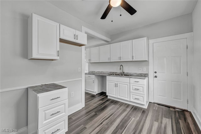 kitchen with white cabinetry, dark hardwood / wood-style flooring, ceiling fan, and sink