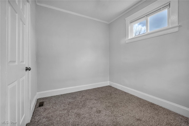 carpeted empty room featuring crown molding