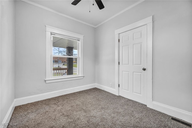 empty room with carpet, ceiling fan, and ornamental molding