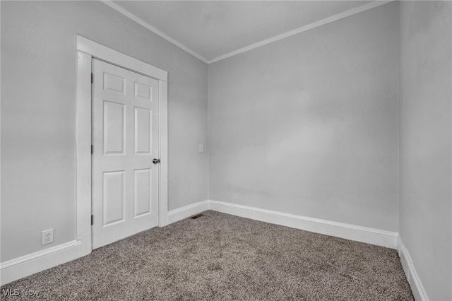 empty room with carpet flooring and ornamental molding