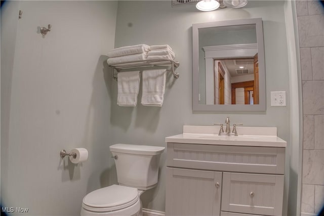 bathroom featuring vanity and toilet