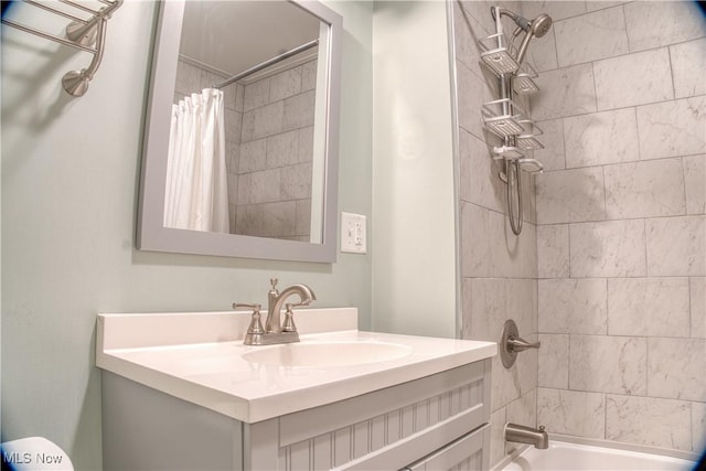 bathroom featuring shower / bath combination with curtain and vanity