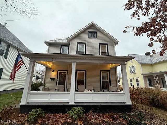 back of property with a porch