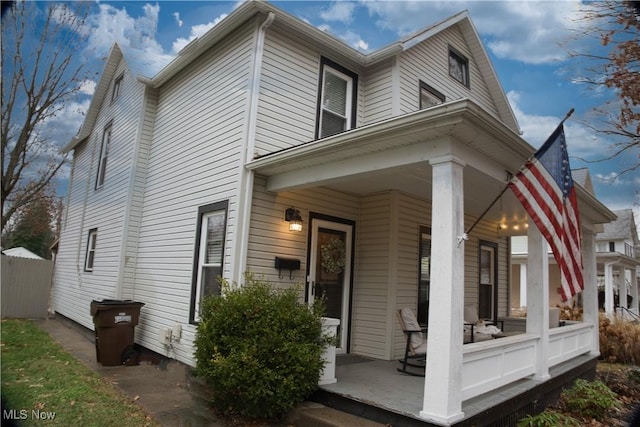 rear view of property with a porch