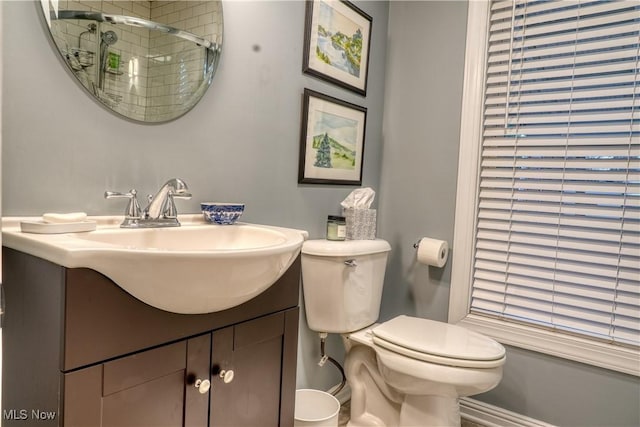 bathroom featuring vanity, an enclosed shower, and toilet